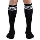 Black knee-high socks with white Macho logo, worn for athletic activities.