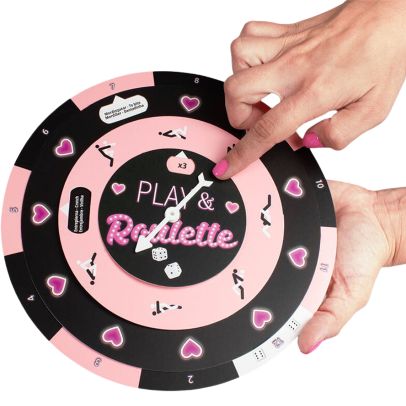 Close-up of hands spinning a 'Play & Roulette' game wheel with hearts and numbers in a playful design.
