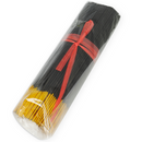 Bundle of black and yellow incense sticks wrapped in plastic with a red ribbon