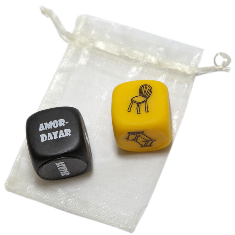 Two dice with symbols and text, one black and one yellow, on a small drawstring pouch.