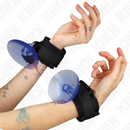 Close-up of hands wearing black wrist cuffs with blue disks, showcasing a unique bondage accessory from the SM & Bondage collection.