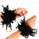 Pair of elegant black feather handcuffs with gold chain, worn on wrists, perfect for adding style and flair to costumes or playful settings.