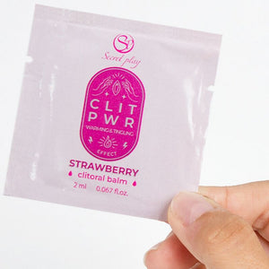 Single-dose strawberry lubricant, 2 ml, in hand. Enhances sensual massage with a smooth texture and natural aroma.
