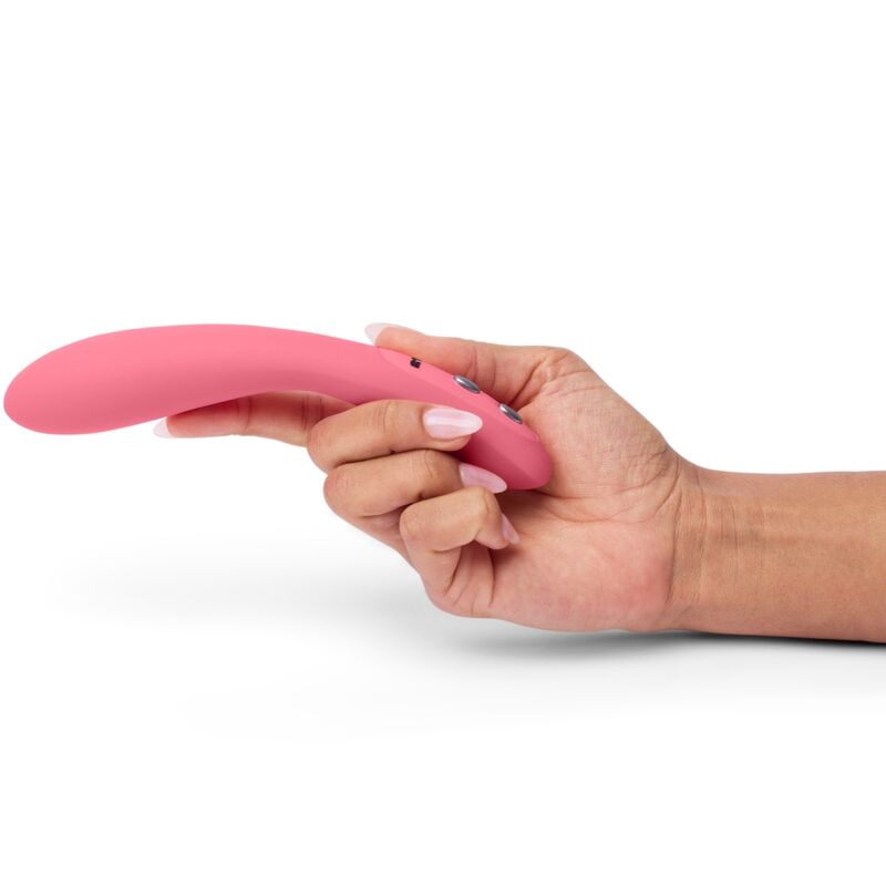 Hand holding pink Je Joue Wand G-Spot Vibrator, showcasing sleek design and powerful vibrations for intimate pleasure.