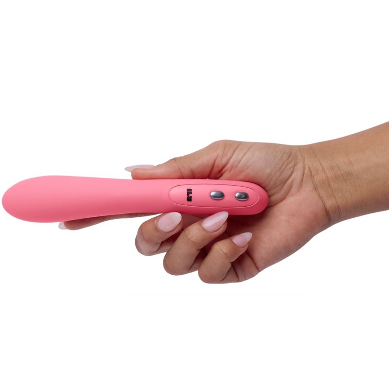 Hand holding JE JOUE pink G-spot vibrator with sleek design and optional warm setting for enhanced pleasure.