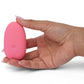 Hand holding pink Je Joue Pebble Clit Vibrator Stimulator, smooth design for enhanced pleasure and self-love sessions.